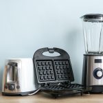 Different household appliances on table in kitchen